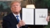 U.S. -- U.S. President Donald Trump signs a document reinstating sanctions against Iran after announcing the US withdrawal from the Iran Nuclear deal, in the Diplomatic Reception Room at the White House in Washington, May 8, 2018