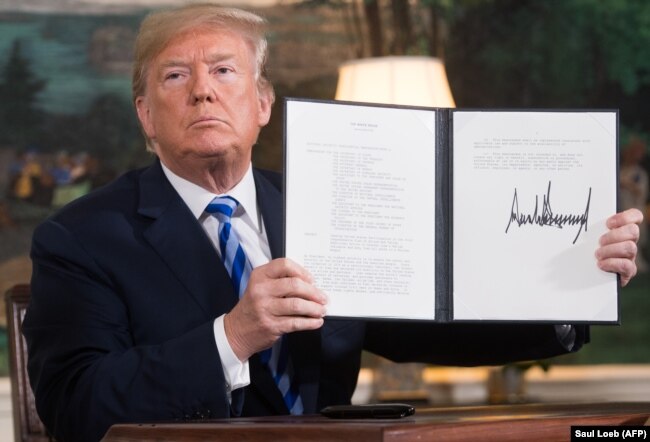 U.S. President Donald Trump signs a document reinstating sanctions against Iran after announcing the U.S. withdrawal from the nuclear deal in the White House in May 2018.