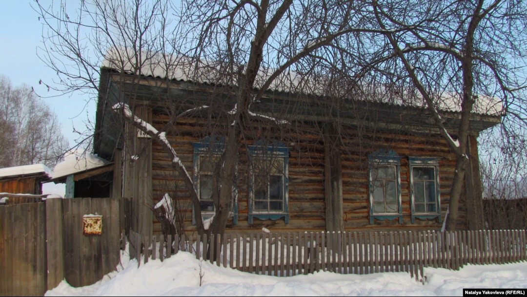 The four-room log house where all 12 members of the Martens family now live.