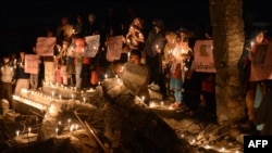 Pakistani Shi'ite Muslims hold candles during a vigil at the site of a bomb attack in Quetta on February 21.