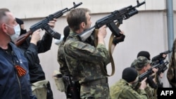 Armed pro-Russia militants attack the regional police building of the eastern Ukrainian city of Luhansk on April 29.