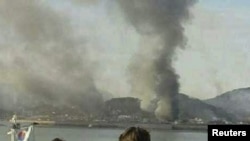 South Korea -- Smoke rises from South Korean Yeonpyeong Island after being hit by dozens of artillery shells fired by North Korea, 23Nov2010