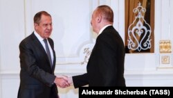 Russian Foreign Minister Sergei Lavrov (left) shakes hands with Azerbaijani President Ilham Aliyev ahead of a meeting in Baku on November 19.