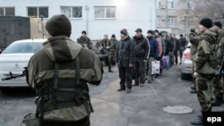Ukrainian prisoners of war stand in line before an exchange of captives with pro-Russia rebels in December 2014. 