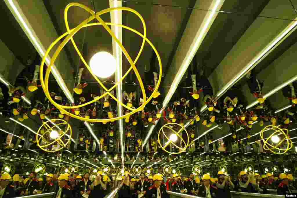 Workers gather under an art installation by Olafur Eliasson at Ukraine&#39;s Interpipe steel mill in Dnipropetrovsk on October 4. (REUTERS/Anatolii Stepanov)