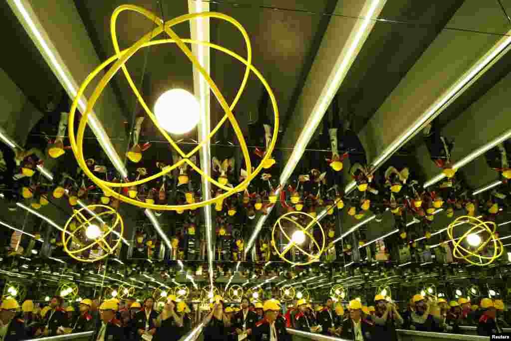Workers gather under an art installation by Olafur Eliasson at Ukraine's Interpipe steel mill in Dnipropetrovsk on October 4. (REUTERS/Anatolii Stepanov)
