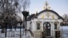На передньому плані так звана «каплиця» УПЦ (Московського патріархату), незаконно збудована біля фундаменту Десятинної церкви на території Національного музею історії України, лютий 2018 року