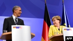 U.S. President Barack Obama (left) and German Chancellor Angela Merkel address a press conference after their bilateral talks at the Herrenhausen Palace in Hannover on April 24.