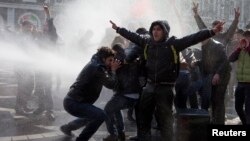 Azerbaijani police use water cannons to break up a crowd of protesters during a rally in Baku in March.