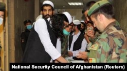 Newly freed Taliban prisoners are processed at Bagram prison, north of Kabul, on April 8.