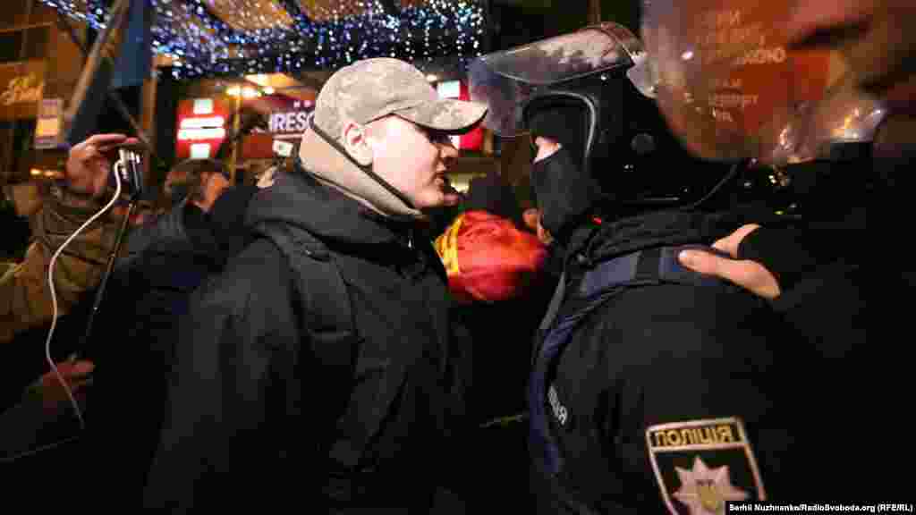 A protester and a policemen face off.