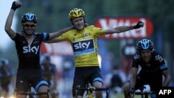 British winner Christopher Froome (center) celebrates with Team Sky teammates after crossing the finish line in Paris of the 100th running of the Tour de France on July 21.