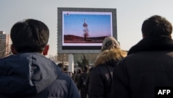 North Koreans in Pyongyang watch a public broadcast of a previous missile launch. (file photo)