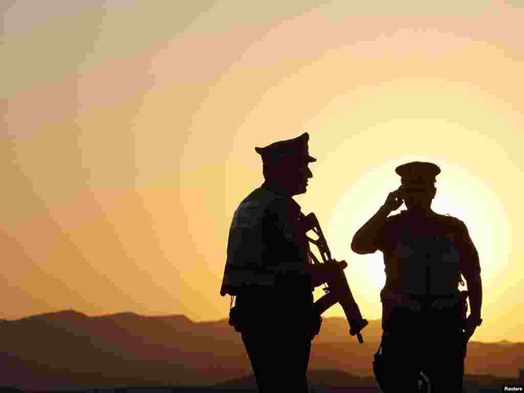 Israeli security officers patrol at a roadblock near Tzihor junction, about 60 kilometers north of the Red Sea resort of Eilat. Gunmen killed seven people in southern Israel in three attacks along the Egyptian border, drawing Israeli accusations that militants from Gaza were responsible and that Cairo's new rulers were losing their grip on a porous frontier.Photo by Ronen Zvulun for Reuters