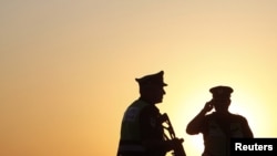 Israeli security officers patrol at a roadblock near the Egyptian border