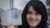 Anastasia Palazhanka brandishes her passport in an undated photo.