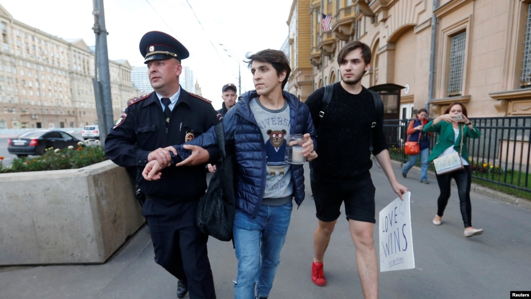 A Russian police officer detains a man as he attempted to place a candle for the victims of the shooting at a gay nightclub in Orlando in front of the U.S. Embassy in Moscow in June.