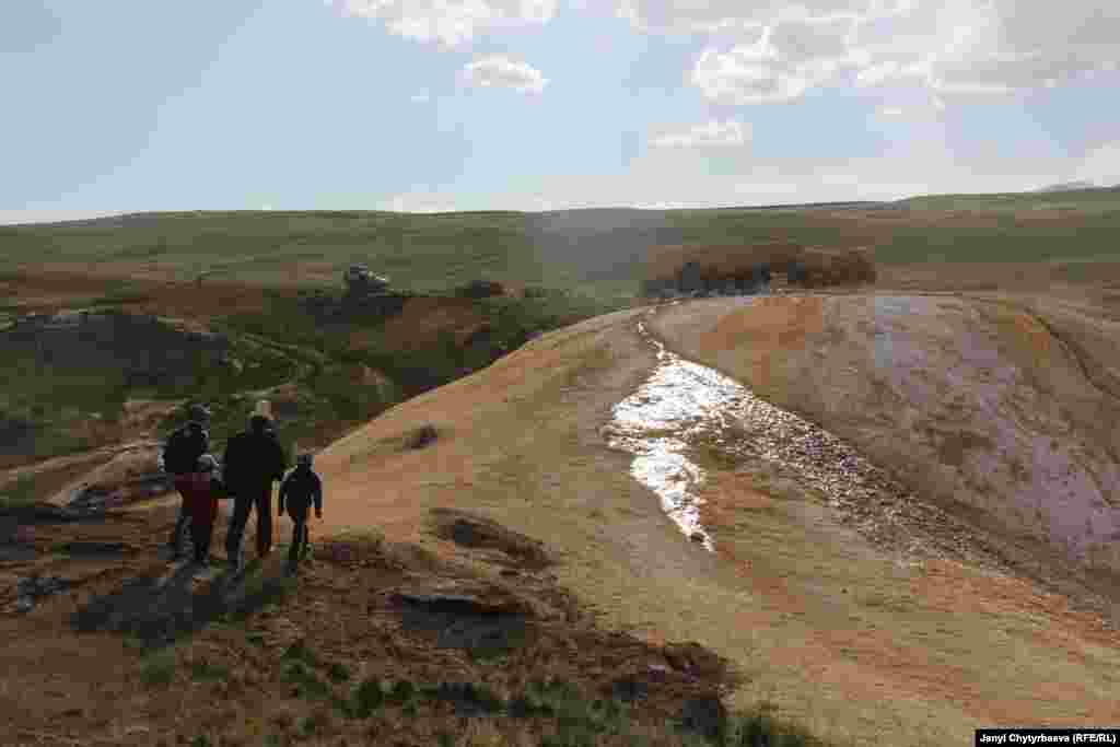 People walk to the Bakpur-Ata shrine in the no-man&#39;s-land between Tajikstan and China. The shrine is believed to have healing powers, but is difficult to reach because of its location in a militarized zone. 