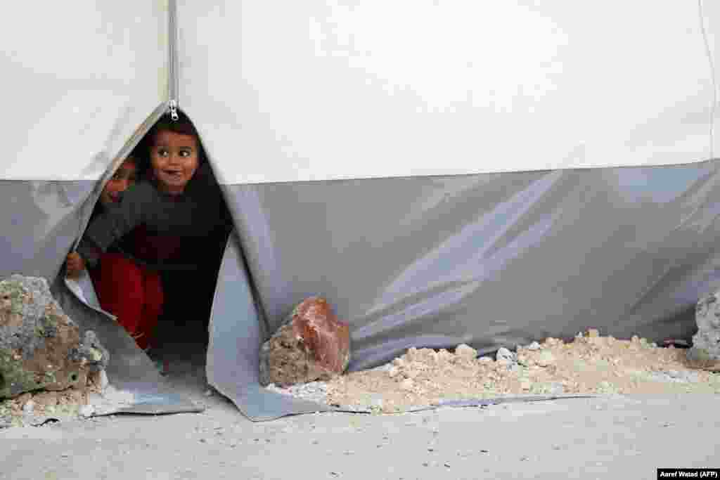 Syrian children evacuated from eastern Ghouta play at a camp for displaced people in Bab al-Hawa, in the northern province of Idlib. (AFP/Aaref WATAD)