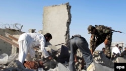 Afghan security officials inspect the site of a suicide bomb blast that targeted security forces in Lashkar Gah, Helmand in early June.