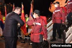 Serbian President Aleksandar Vucic (without mask) welcomes Chinese health experts and a planeload of Chinese medical supplies to Belgrade on March 21, 2020.