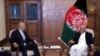 Afghan President Ashraf Ghani (right) meets with U.S. envoy Zalmay Khalilzad in Kabul in July.