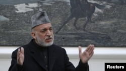 Afghan President Hamid Karzai speaks during a meeting at the presidential palace in Kabul with the family members of civilians allegedly killed by a U.S. soldier in Kandahar last week.