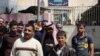 مراجعون يخرجون من مركز للتشغيل في الموصل