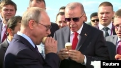 Putin și invitatul său Erdogan gustând înghețată "Vaca din Korenovka" la salonul de aviație MAKS, 27 august 2019. 