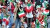 Iranian women cheer ahead of the World Cup Qatar 2022 Group C qualification football match between Iran and Cambodia at the Azadi stadium in the capital Tehran on October 10, 2019.