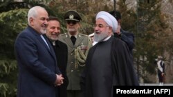 File photo - Iranian President Hassan Rouhani, right, speaks with Foreign Minister Mohammad Javad Zarif, at the Saadabad Palace in Tehran, February 27, 2019