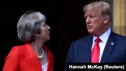 British Prime Minister Theresa May poses for a photograph with U.S. President Donald Trump at Chequers near Aylesbury, July 13, 2018