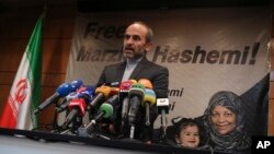 Paiman Jebeli, deputy chief of Iran's state IRIB broadcaster gives a press briefing Jan. 16, 2019. Marzieh Hashemi, shown in banner,