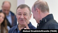 Ресейлік олигарх Аркадий Ротенберг (сол жақта) президент Владимир Путинмен бірге Қырым түбегін Ресеймен жалғайтын көпірдің ашылу салтанатында. 10 мамыр 2018 жыл.