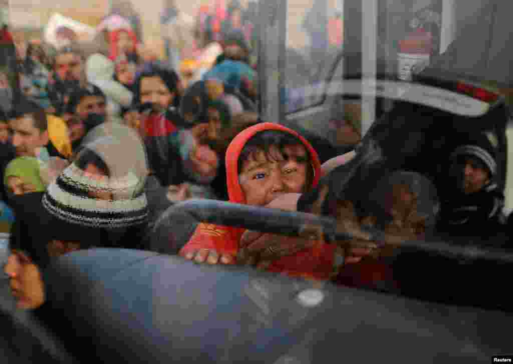 Iraqis flee the Islamic State stronghold in the town of Bartella, east of Mosul, on December 28. (Reuters/Ammar Awad)