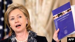 U.S. -- U.S. Secretary of State Hillary Rodham Clinton holds up a copy of the 2010 Trafficking in Persons Report during an event at the State Department in Washington, DC. , 14Jun2010