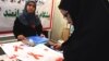 A woman reads a leaflet at an exhibition marking World AIDS Day in Tehran in 2008. Activists are concerned that the calendar change will mean even less public attention paid to an issue that is already a social taboo in Iran.