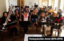 Afghan music students play their instruments during a practice session at the Afghan National Institute of Music in Kabul in 2018.