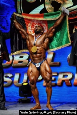 Award-winning Afghan bodybuilder Yasin Qaderi during a 2018 competition.