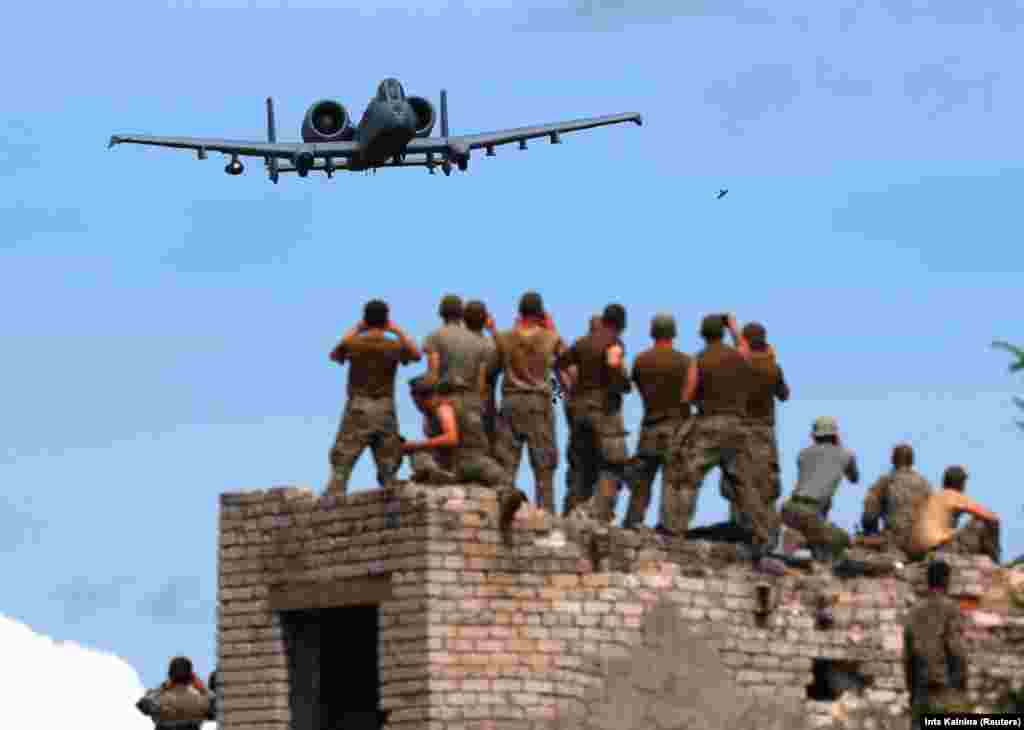 A U.S. aircraft takes part in an urban-fighting drill during NATO Saber Strikes exercises near Skrunda in Latvia. (Reuters/Ints Kalnins)