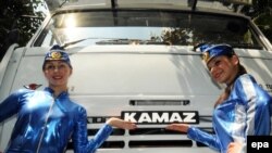 Russian models pose with a newly launched GVW 31T dump truck during a press conference in the southern Indian city of Bangalore on February 25.