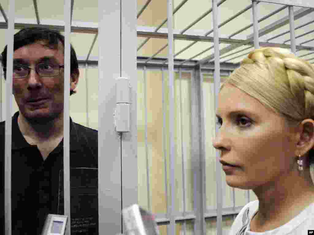 Former Ukrainian Interior Minister Yuriy Lutsenko seen in a defendant's cage as former Ukrainian Prime Minister Yulia Tymoshenko stands at right in a courtroom in Kyiv on May 23. Tymoshenko's top ally was detained in late December on charges of abuse of office. Photo by Sergei Chuzavkov for AP