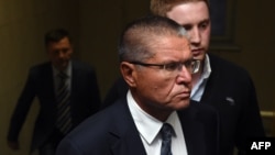 Aleksei Ulyukayev is escorted before a hearing at the Basmanny district court in Moscow on November 15.