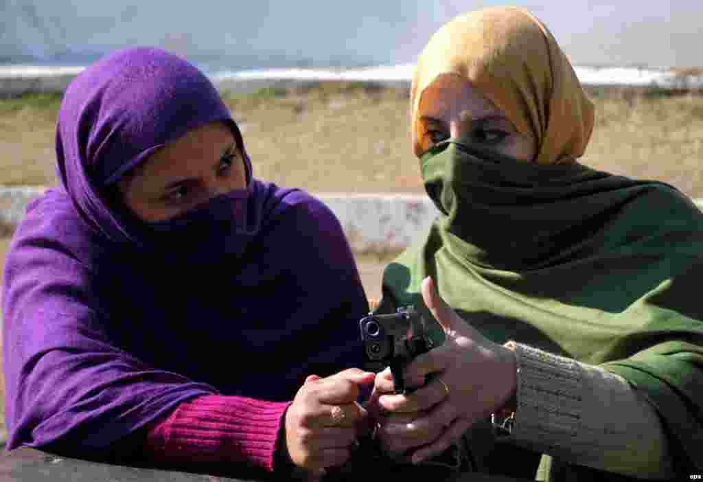 Pakistani schoolteachers hold a gun during a training session in Peshawar, Pakistan. The provincial government launched special gun-training sessions for female teachers in the city after a Taliban attack against an army-run school killed at least 136 students. (epa/Arshad Arbab) 