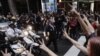 U.S. - New York Police Department officers on motor scooters confront members of the Occupy Wall Street movement during a march through the financial district of New York, 14Oct2011