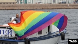 An activist holds a rainbow flag during a gay pride event in St. Petersburg in June.