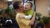 Aaron Moyer holds Vitaly during a visit to his Russian orphanage, before the adoption ban was instituted. Vitaly, who has Down syndrome and a life-threatening heart condition, still lives in an orphanage.