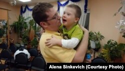 Aaron Moyer holds Vitaly during a visit to his Russian orphanage, before the adoption ban was instituted. Vitaly, who has Down syndrome and a life-threatening heart condition, still lives in an orphanage.