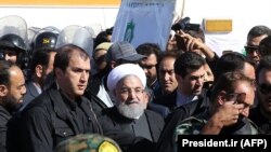 Iranian President Hassan Rohani (C) visits the earthquake-hit area of Sarpol-e Zahab in Iran's western province of Kermanshah, November 14, 2017