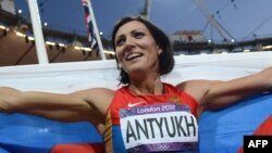 Russia's Natalya Antyukh holds her national flag as she celebrates winning the women's 400-meter hurdles final at the London 2012 Olympic Games on August 8.